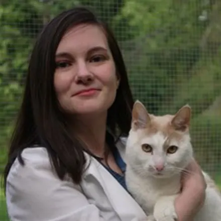 Portrait of Dr. Kristina Modjeski holding a white cat
